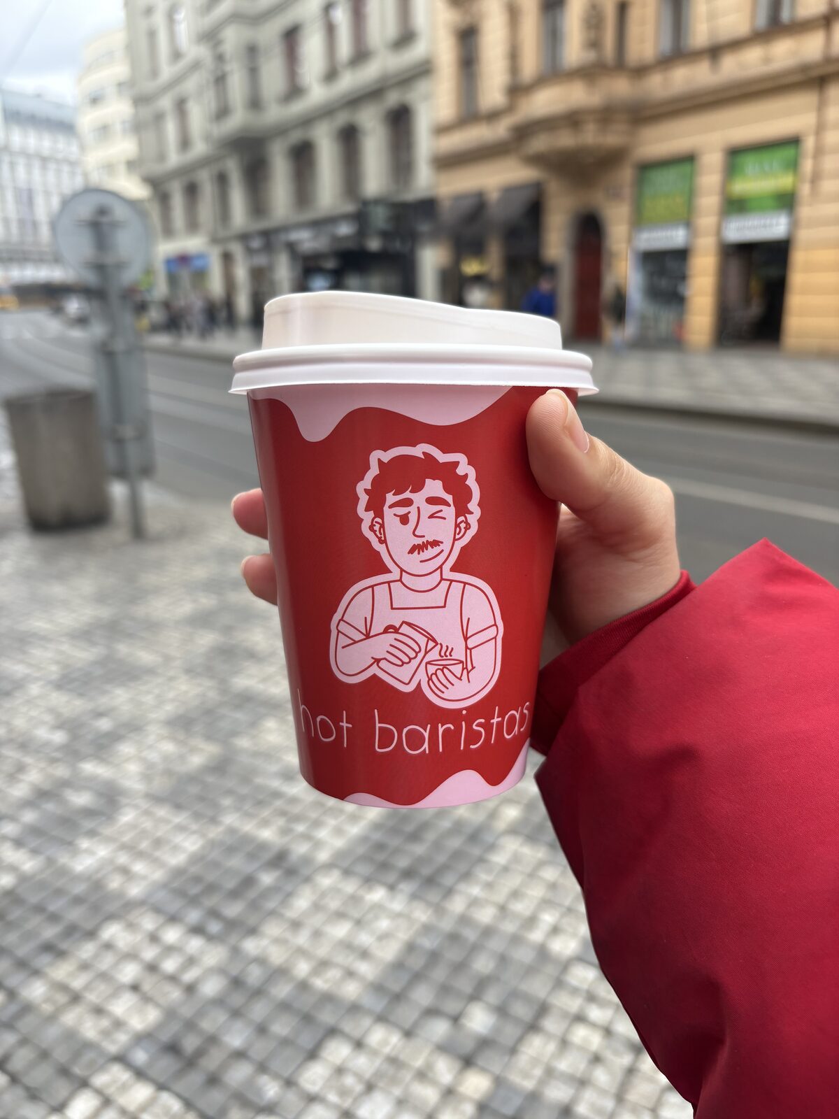 Hot Baristas cup carried through the streets of Prague