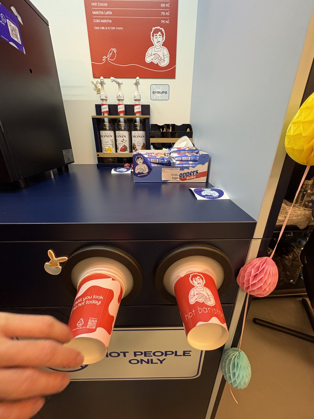 Branded paper cups dispensed from the Hot Baristas station